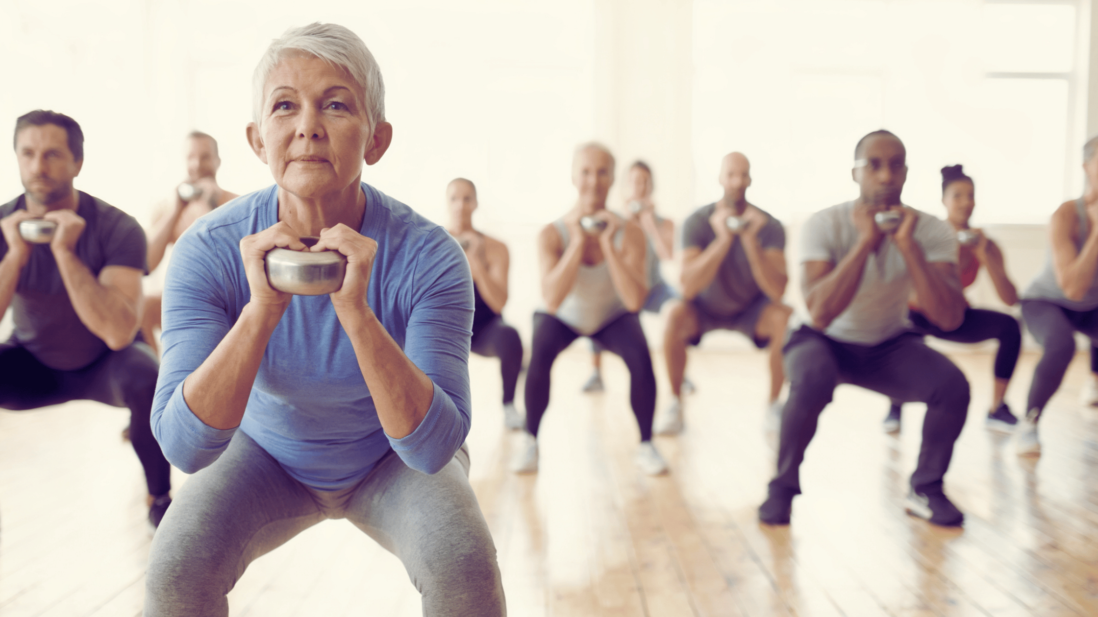 Older woman doing a goblet squat with a dumbbell to build leg strength for longevity and brain health