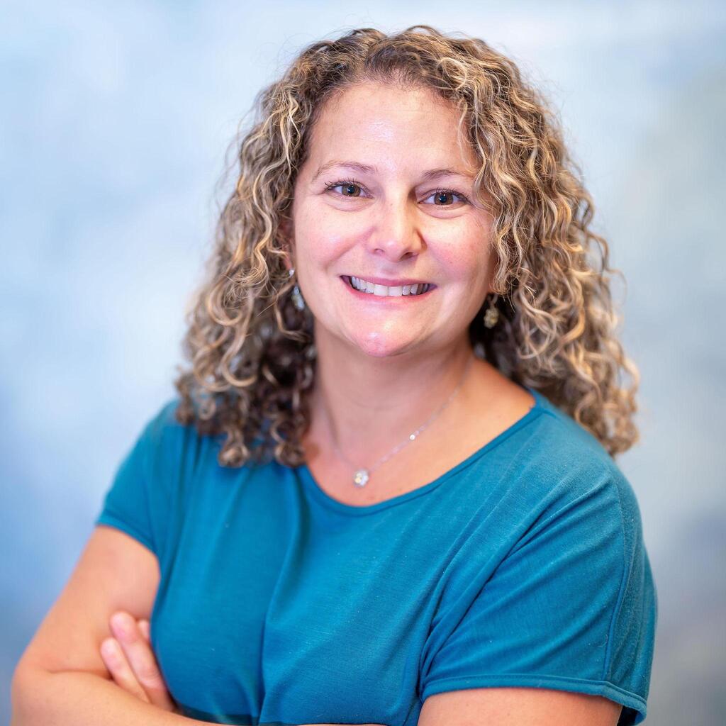 Professional headshot of staff member Esther Bizzarro