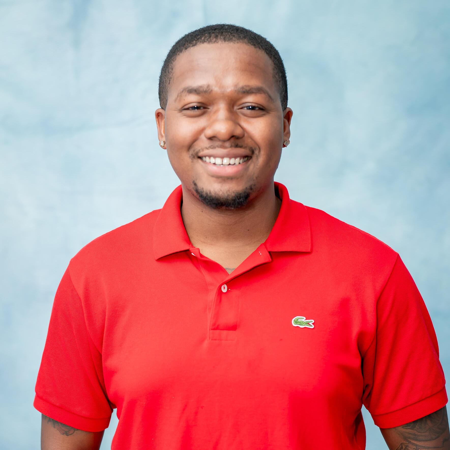 Staff member headshot in red polo shirt