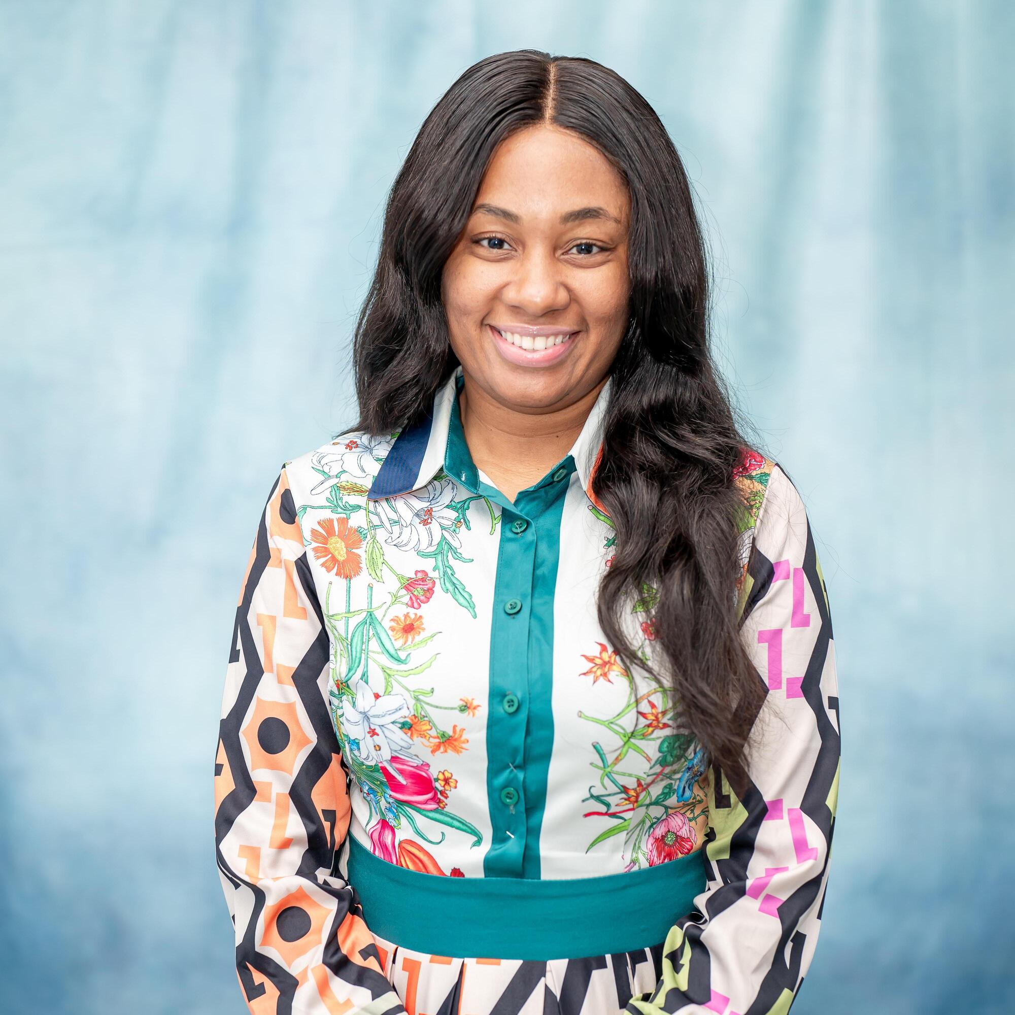 Professional headshot of staff member smiling in colorful blouse