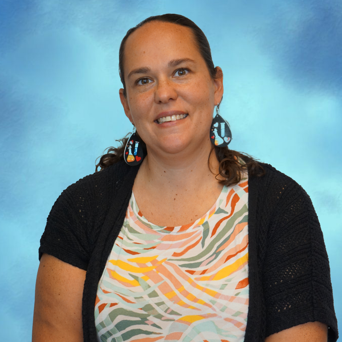 Staff member portrait photo against blue background