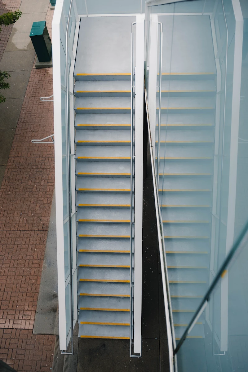 Clean outdoor concrete stairway with safety striping after professional power washing.