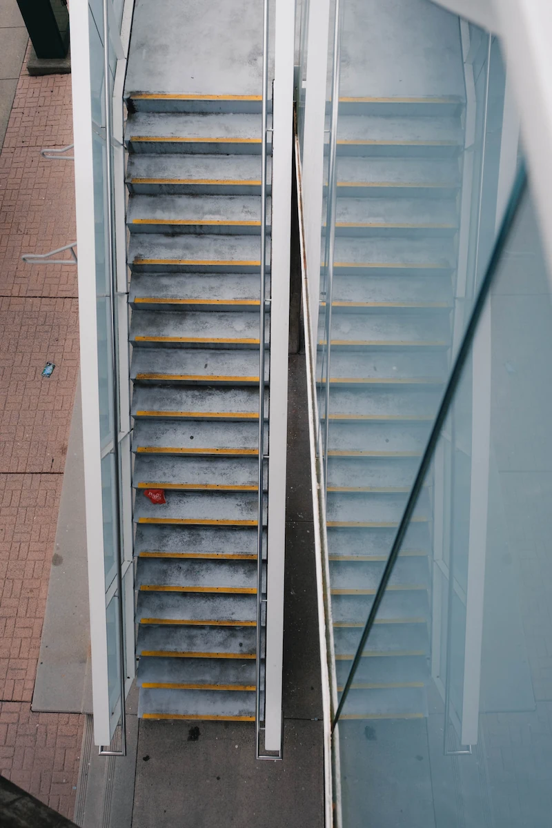 Outdoor concrete stairway with dirt and stains before power washing service.