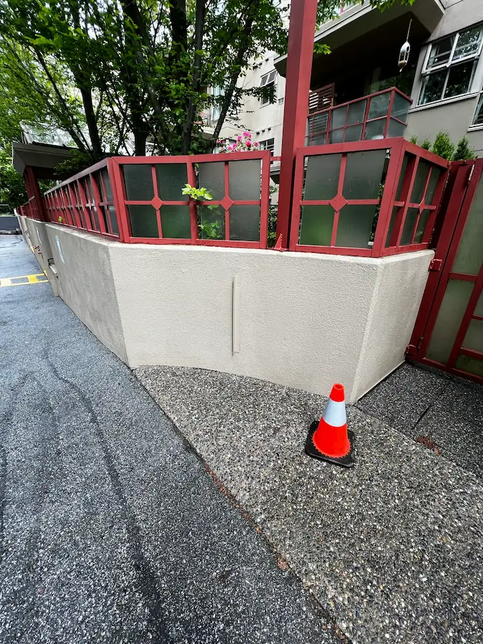 Clean residential stucco wall after professional soft washing, with bright surface restored and free of dirt.