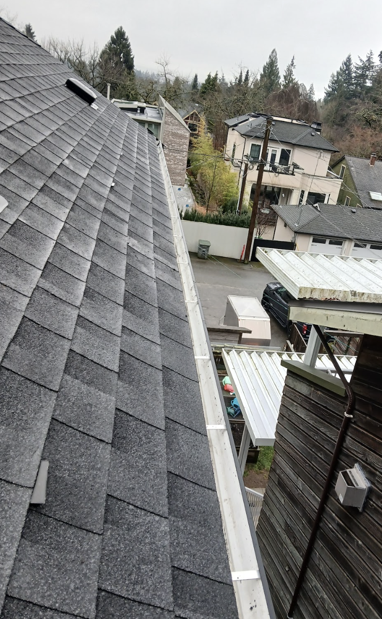 Gutter cleaning on multi-story building in Vancouver.