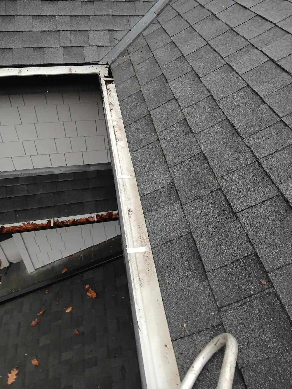 Residential gutters after professional gutter cleaning, fully cleared of leaves and debris with proper water flow restored in Vancouver.