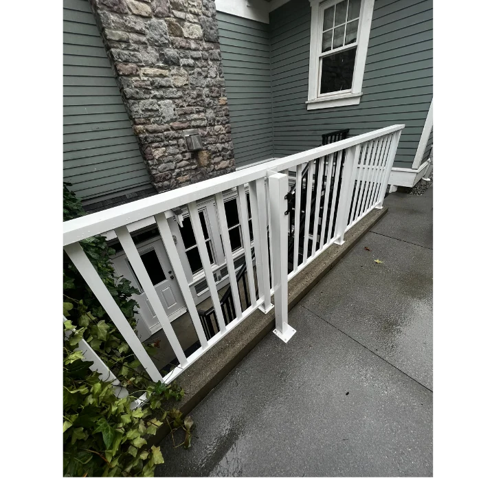 Concrete balcony and white railing after professional power washing service to remove dirt and buildup.
