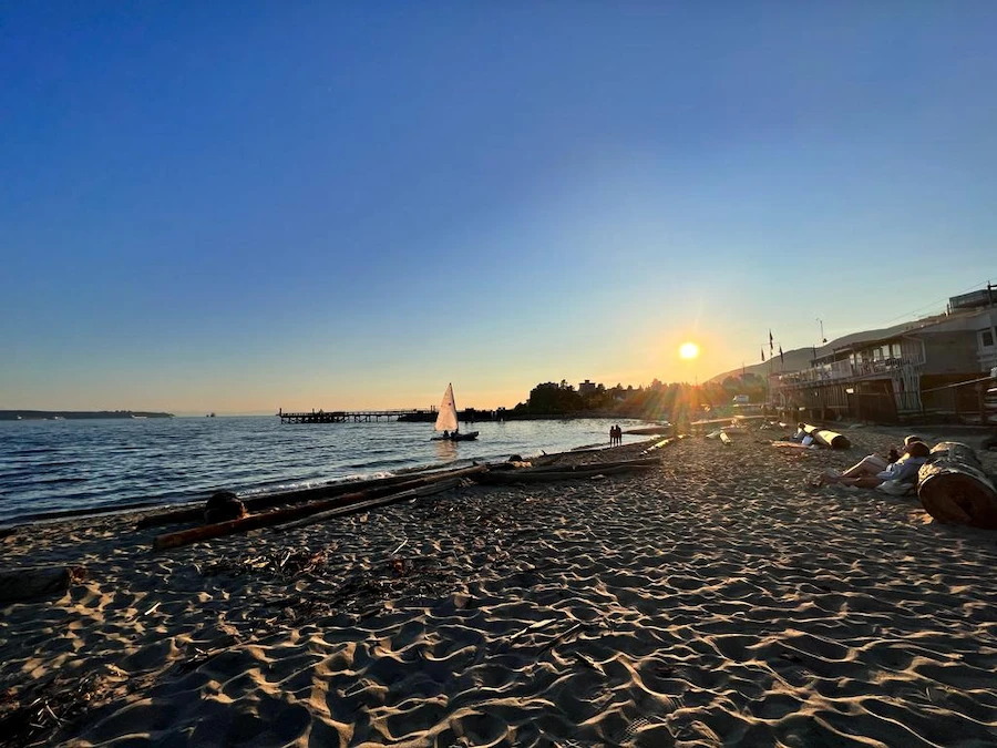 Ambleside Beach in West Vancouver at sunset; sailboat on calm water; trusted exterior and window cleaning experts.