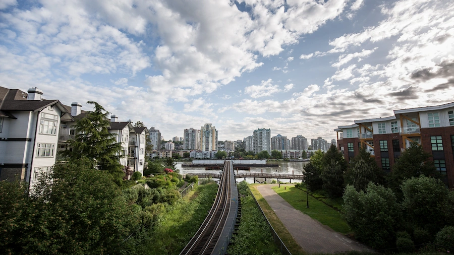 View of the railway and residential area in Queensborough, New Westminster; trusted roof, gutter, and exterior cleaning experts.