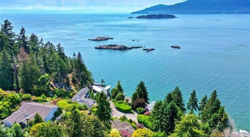 Homes nestled in the forested hills of Upper Lion’s Bay overlooking the ocean; expert roof and exterior cleaning services.