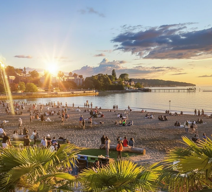 Kitsilano Beach in Vancouver at sunset with people by the water; trusted exterior, roof, and window cleaning experts.