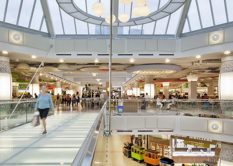 Interior of Metropolis at Metrotown with shoppers and glass skylight; professional exterior and window cleaning services for Burnaby businesses.