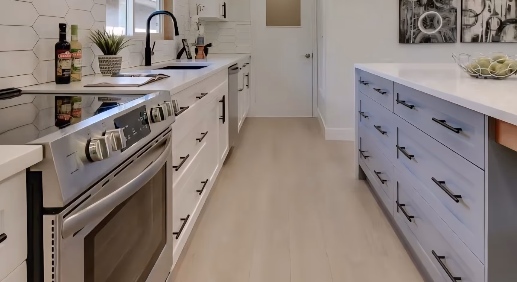 Kitchen with white and grey nextek cabinets and wood floor.