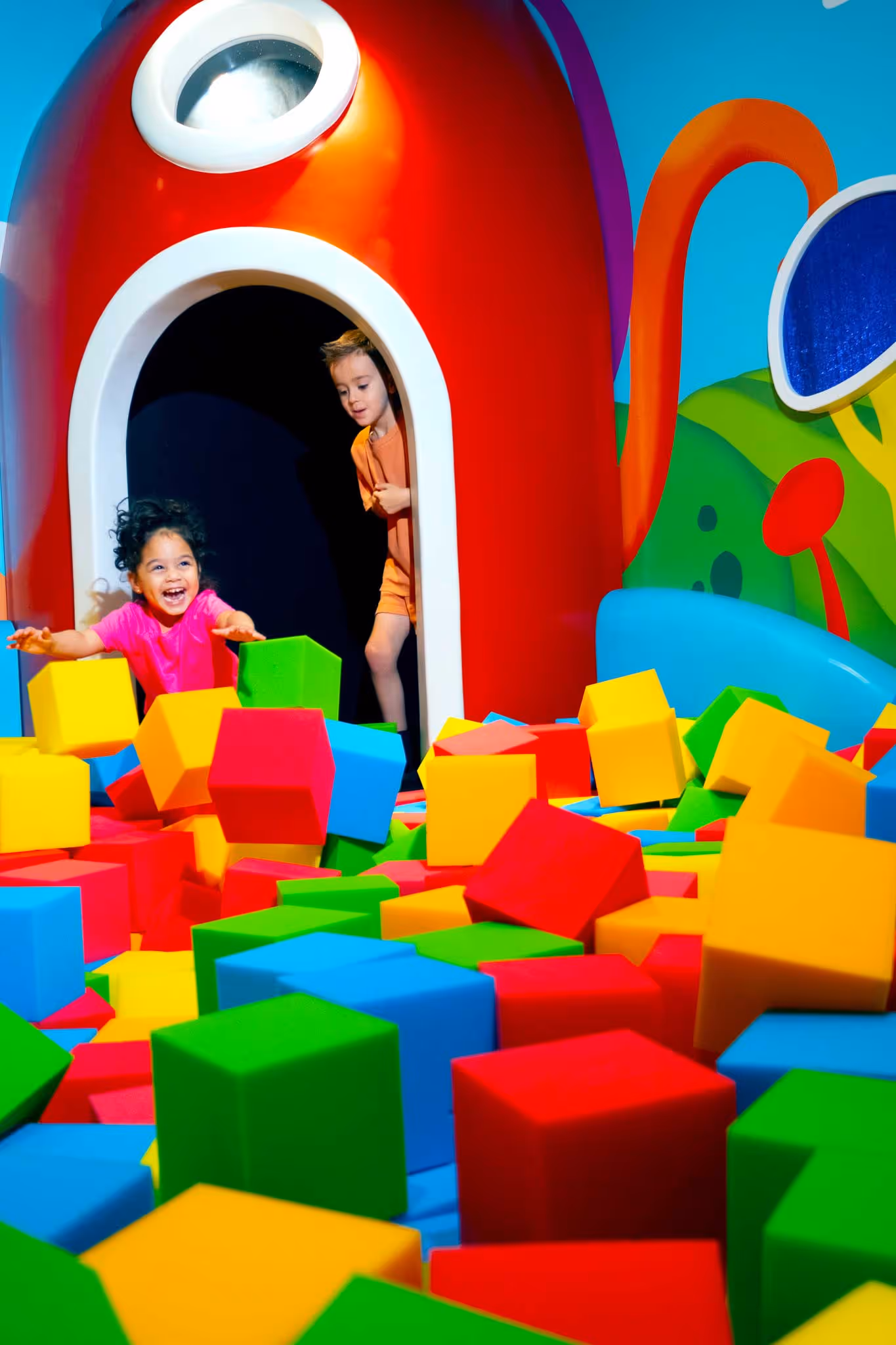 Kids playing in the foam cube pit in Play Doh's Imagination Station in Planet Playskool.