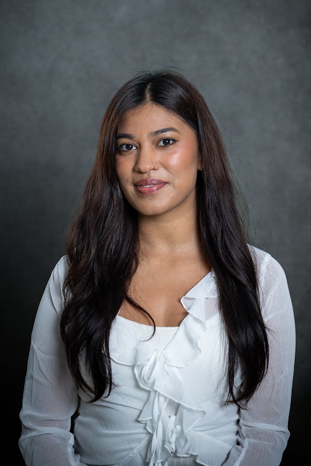 Professional headshot of staff member T. Tanas