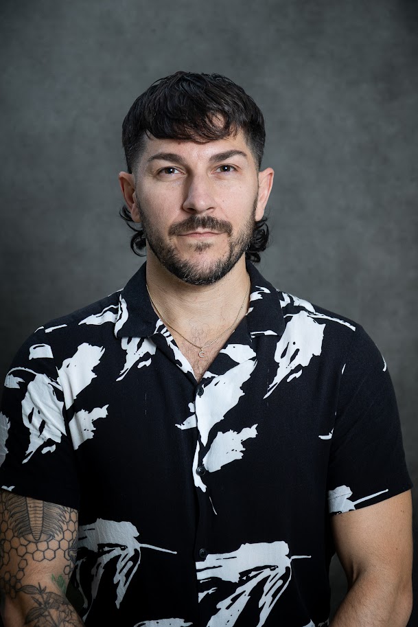 Male staff member with beard in patterned shirt