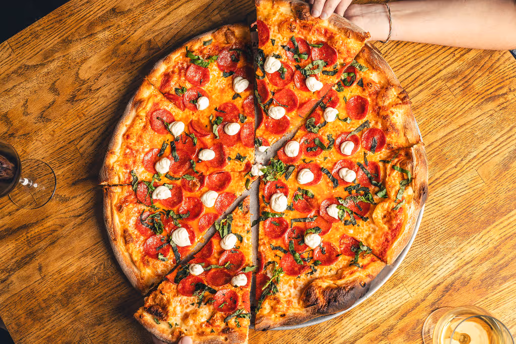 A picture of a pizza on a table at a Colorado based restaurant taken by Gaze Marketing (Also known as Gaze Productions)