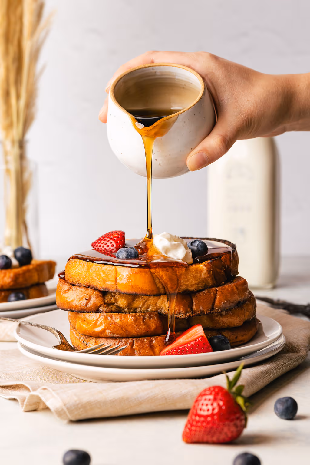 A picture of syrup being poured on pancakes taken by the marketing company Gaze Marketing also known as Gaze productions.