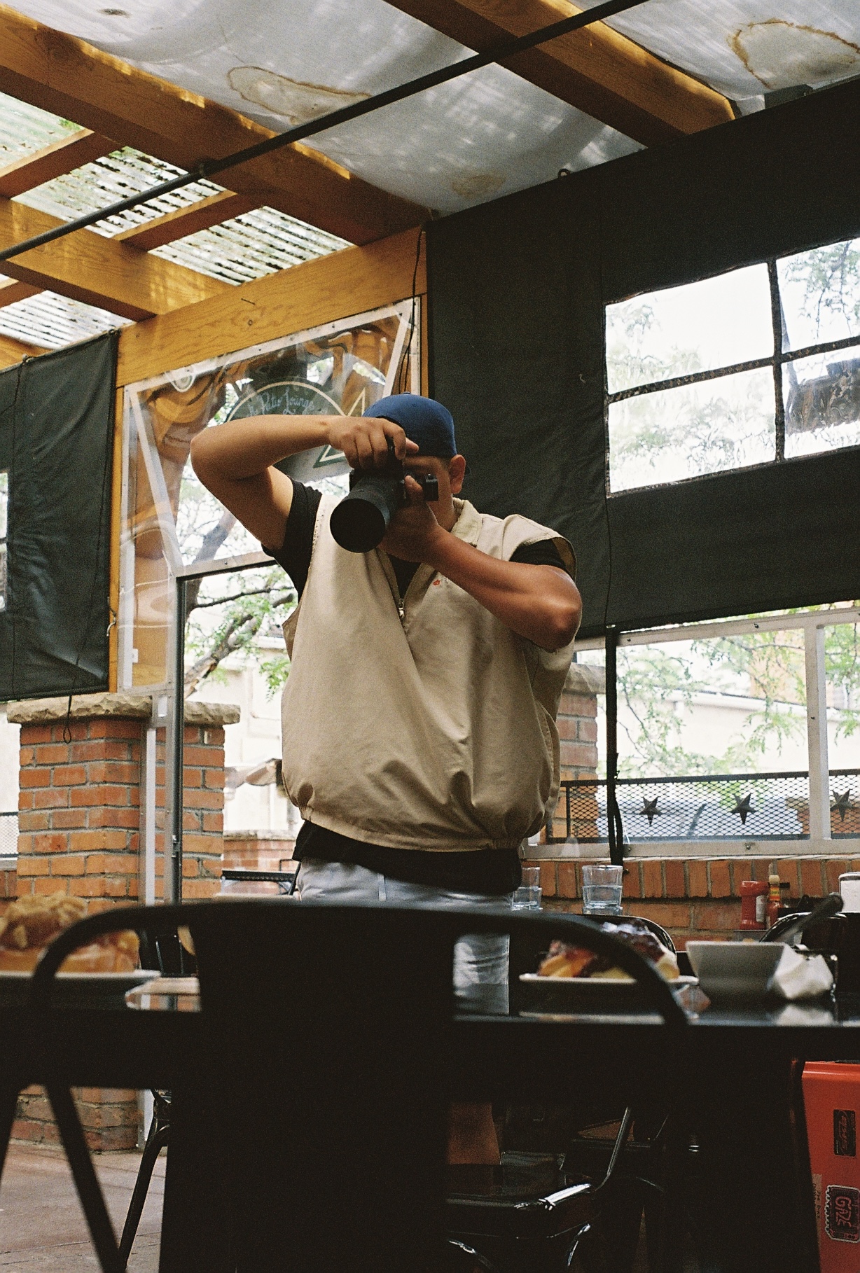 A image of one of the Gaze Productions team members taking a picture at a well known Colorado based restaurant.
