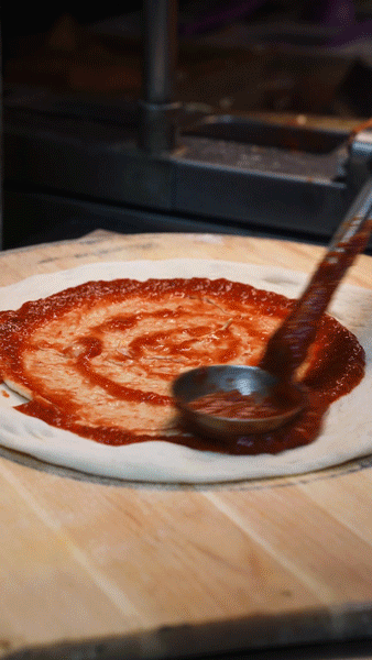 A gif of a pizza being made at the Colorado restaurant Wholly Stromboli
