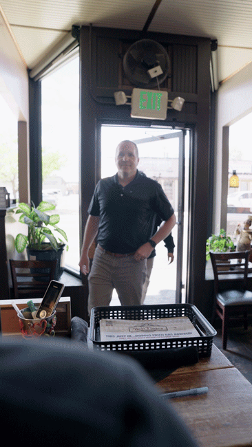 A gif of two people walking into the Colorado restaurant Wholly Stromboli