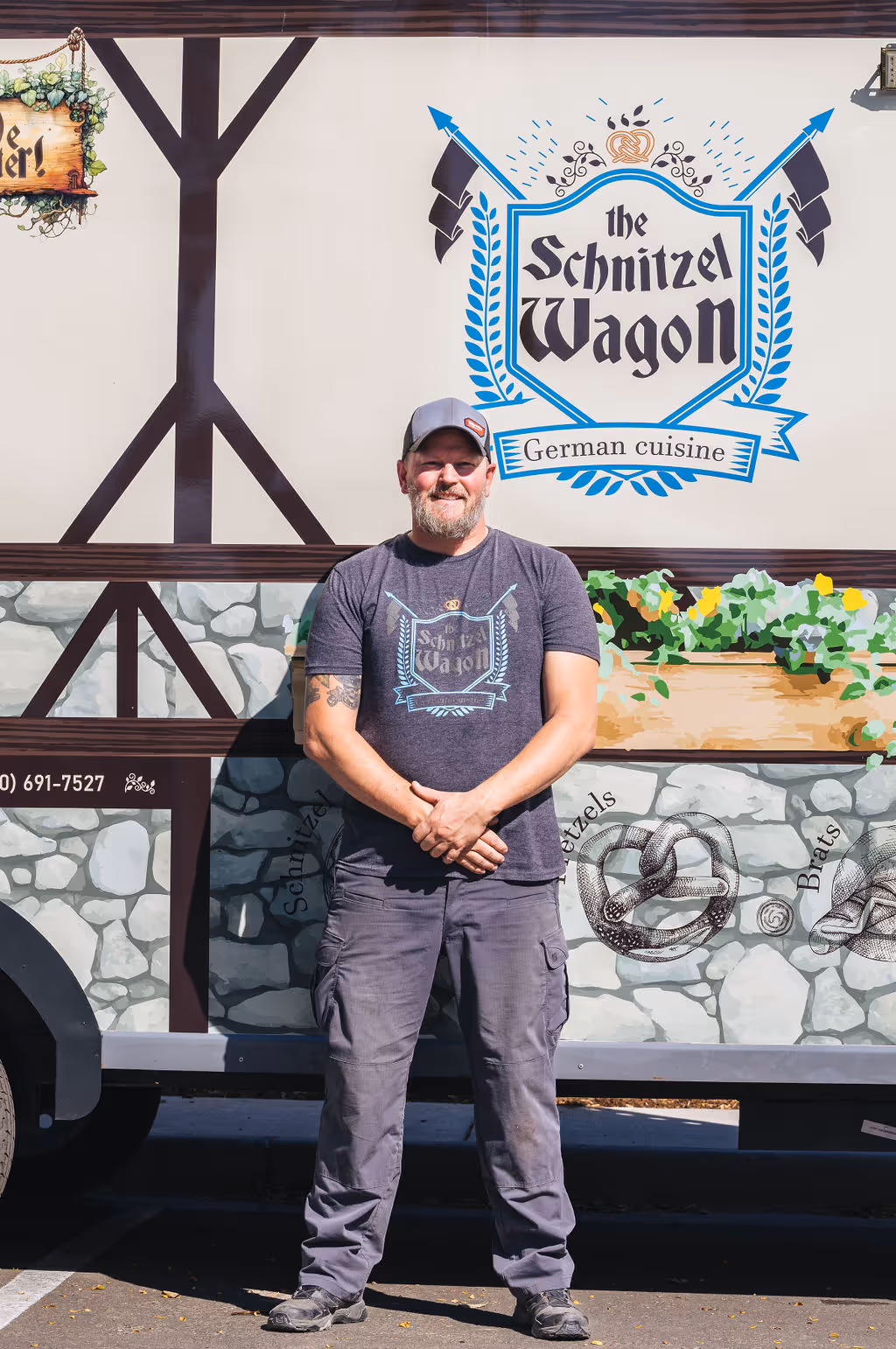 A man standing in front of a food truck.