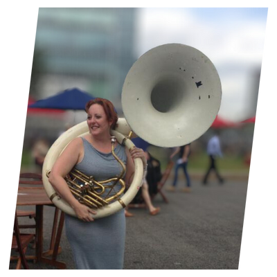 Jenn Day with a sousaphone in Canary Wharf.