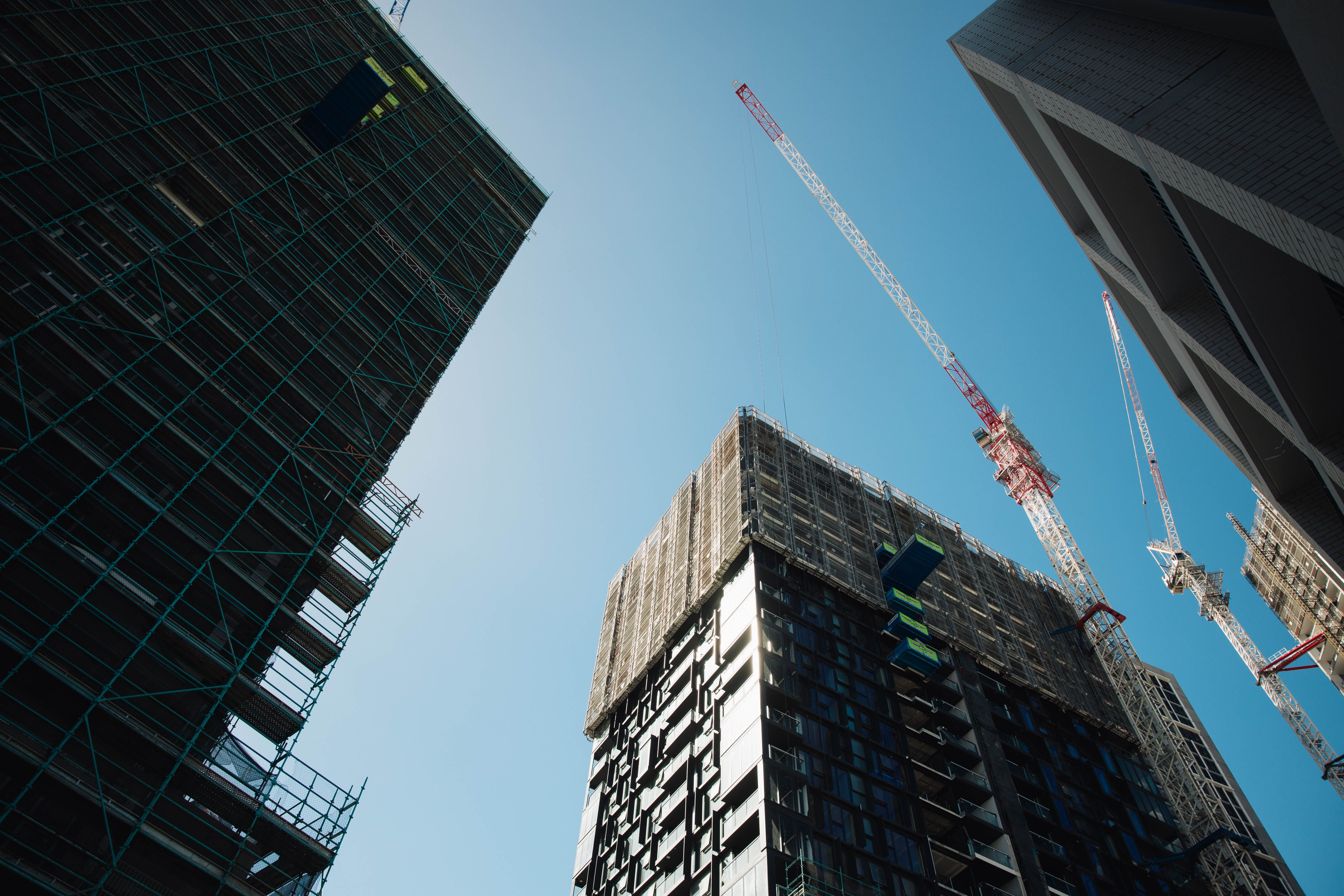 Worm's-eye view of two modern buildings against a clear sky