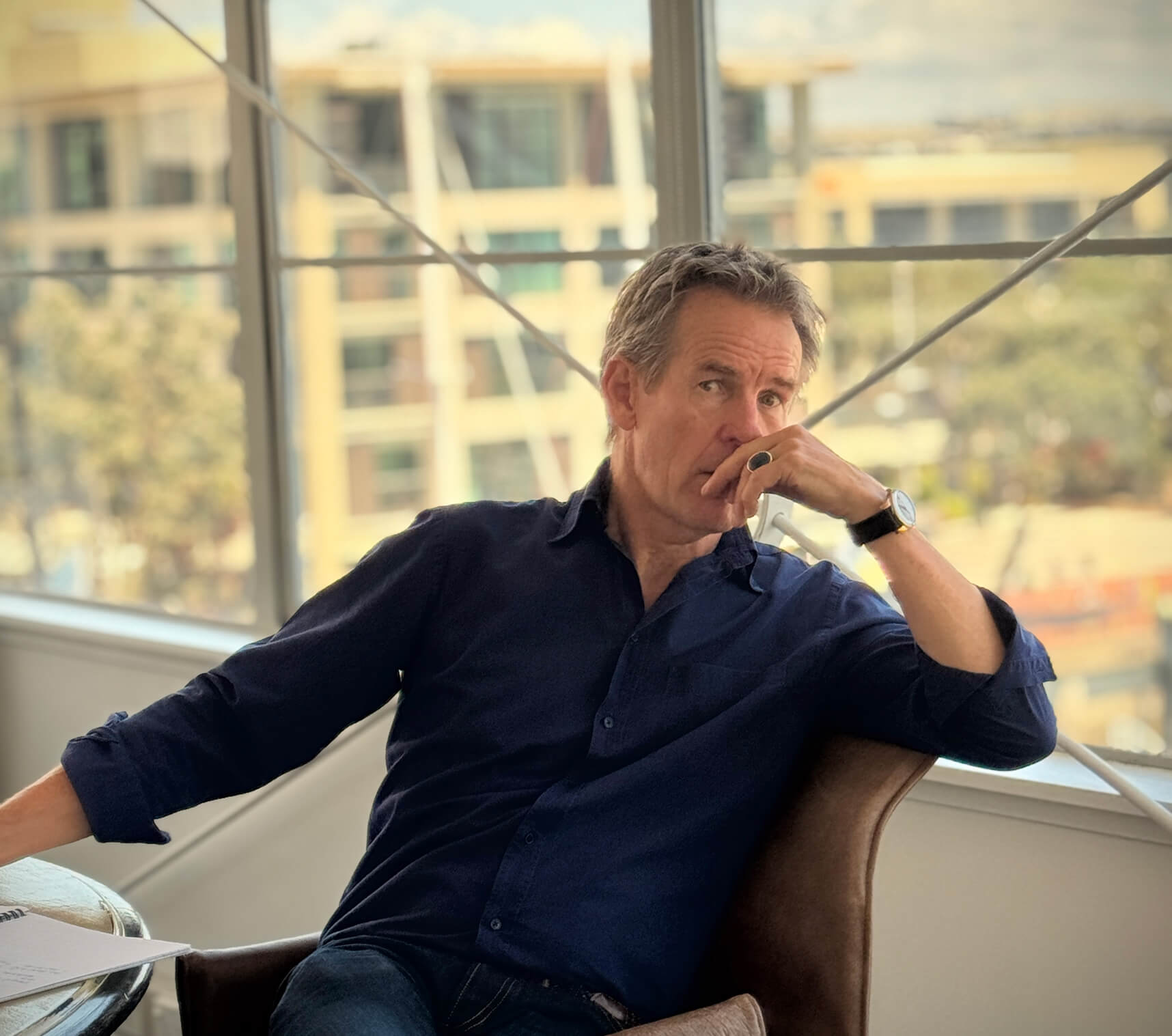 John McConnell sitting at a desk in an office building.