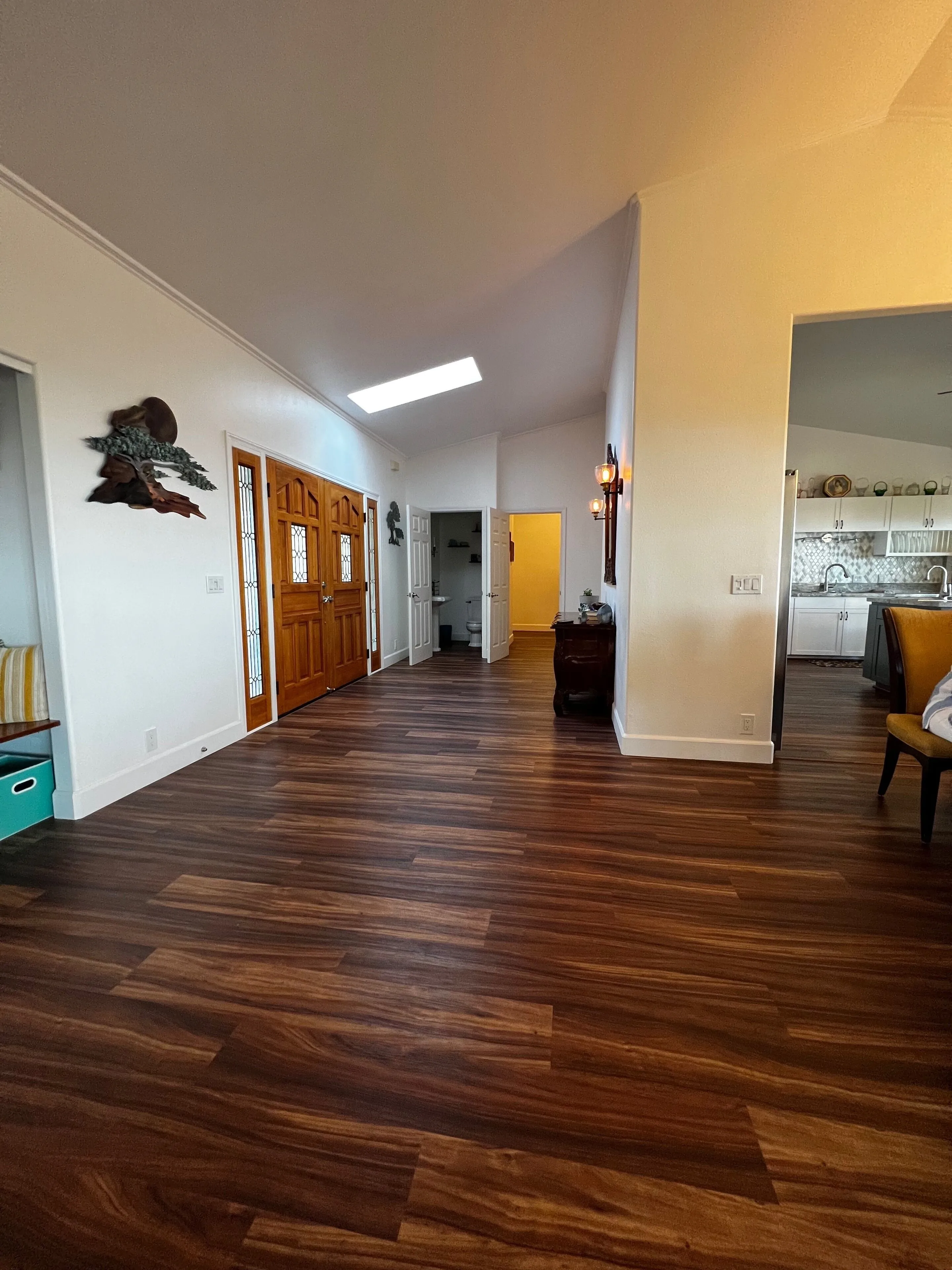 Entry hall with vaulted ceiling and hardwood floors