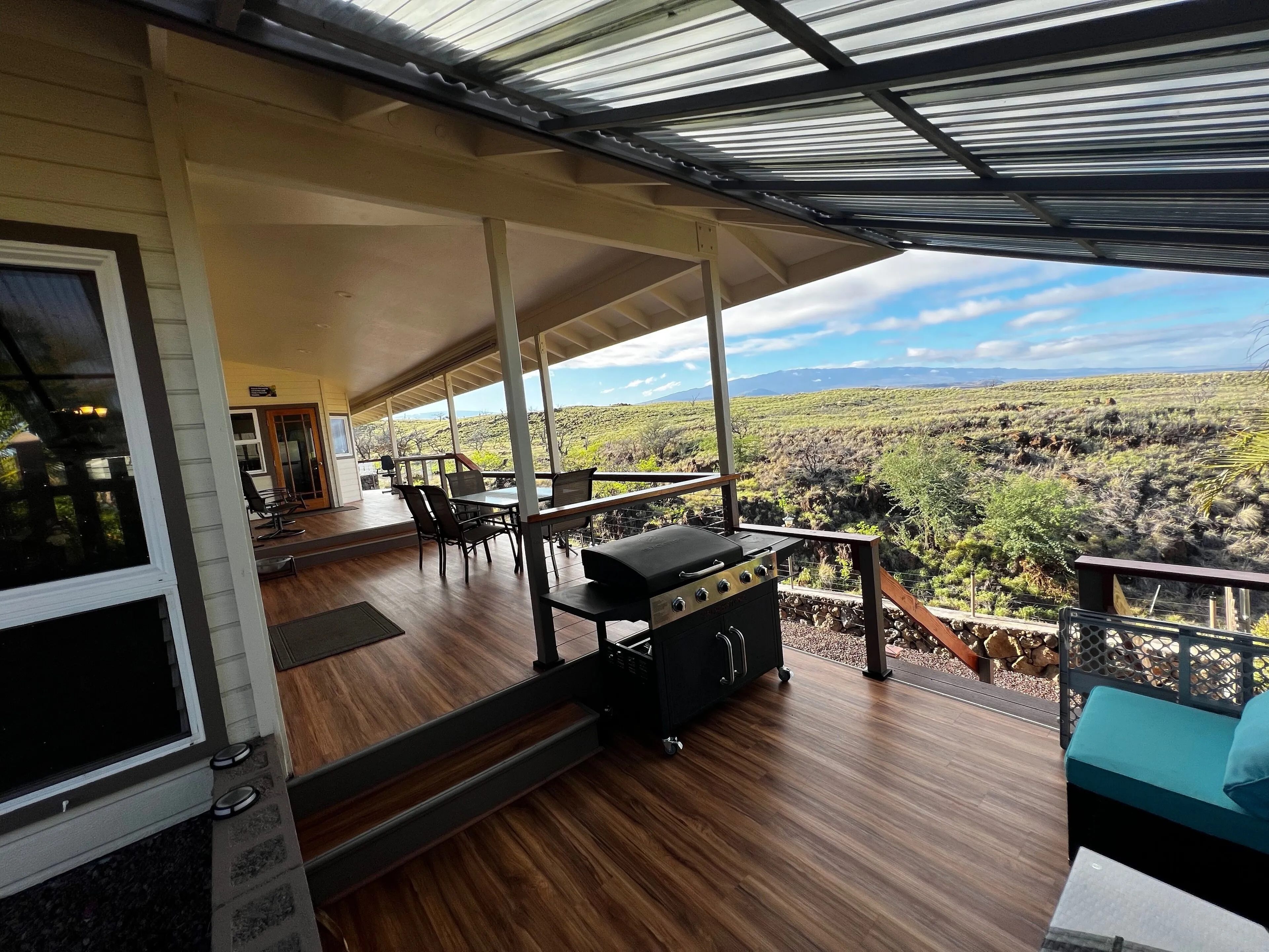 Covered lanai with grill and outdoor dining overlooking the coast