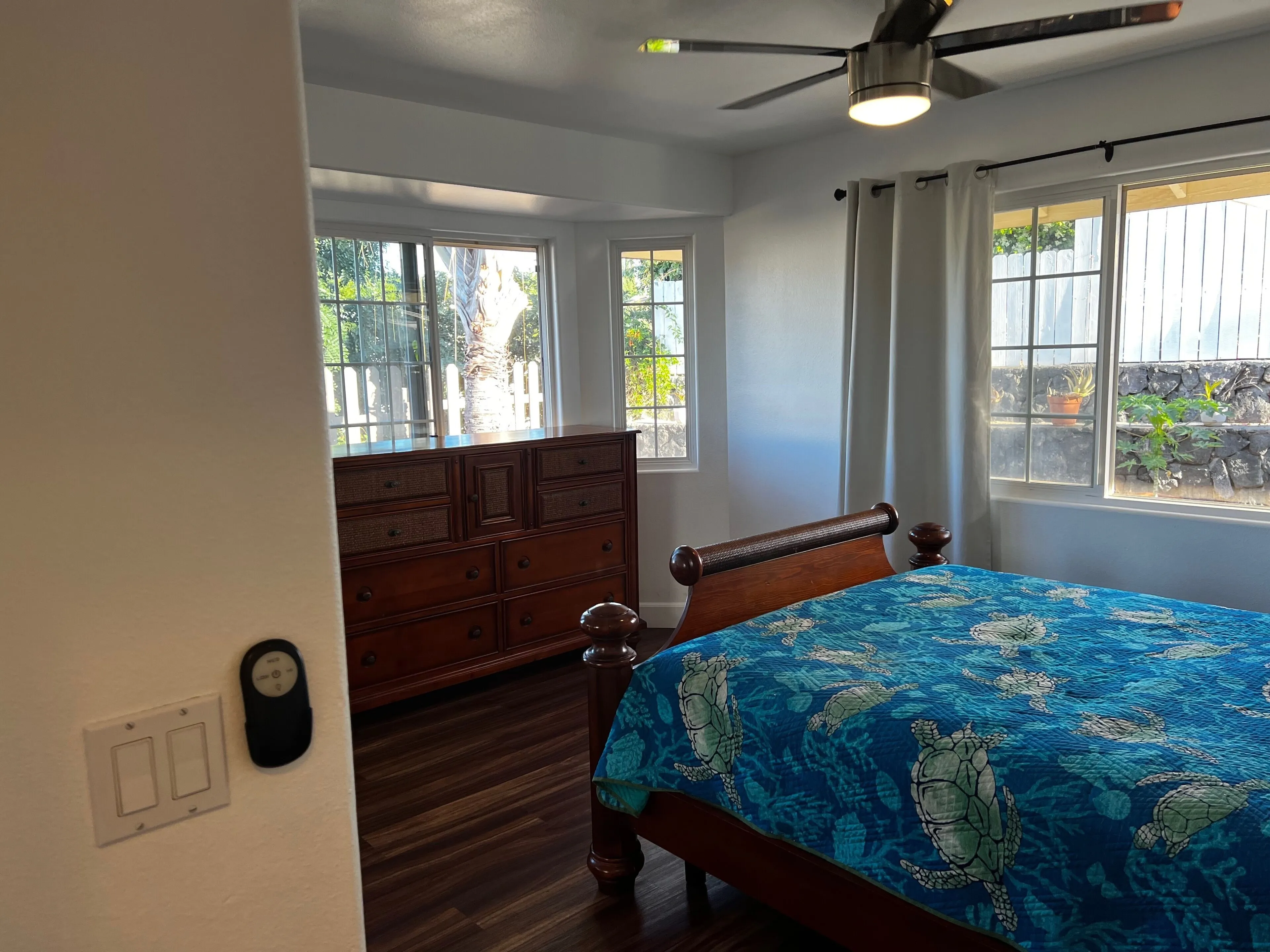 Guest bedroom with queen bed and bright corner windows