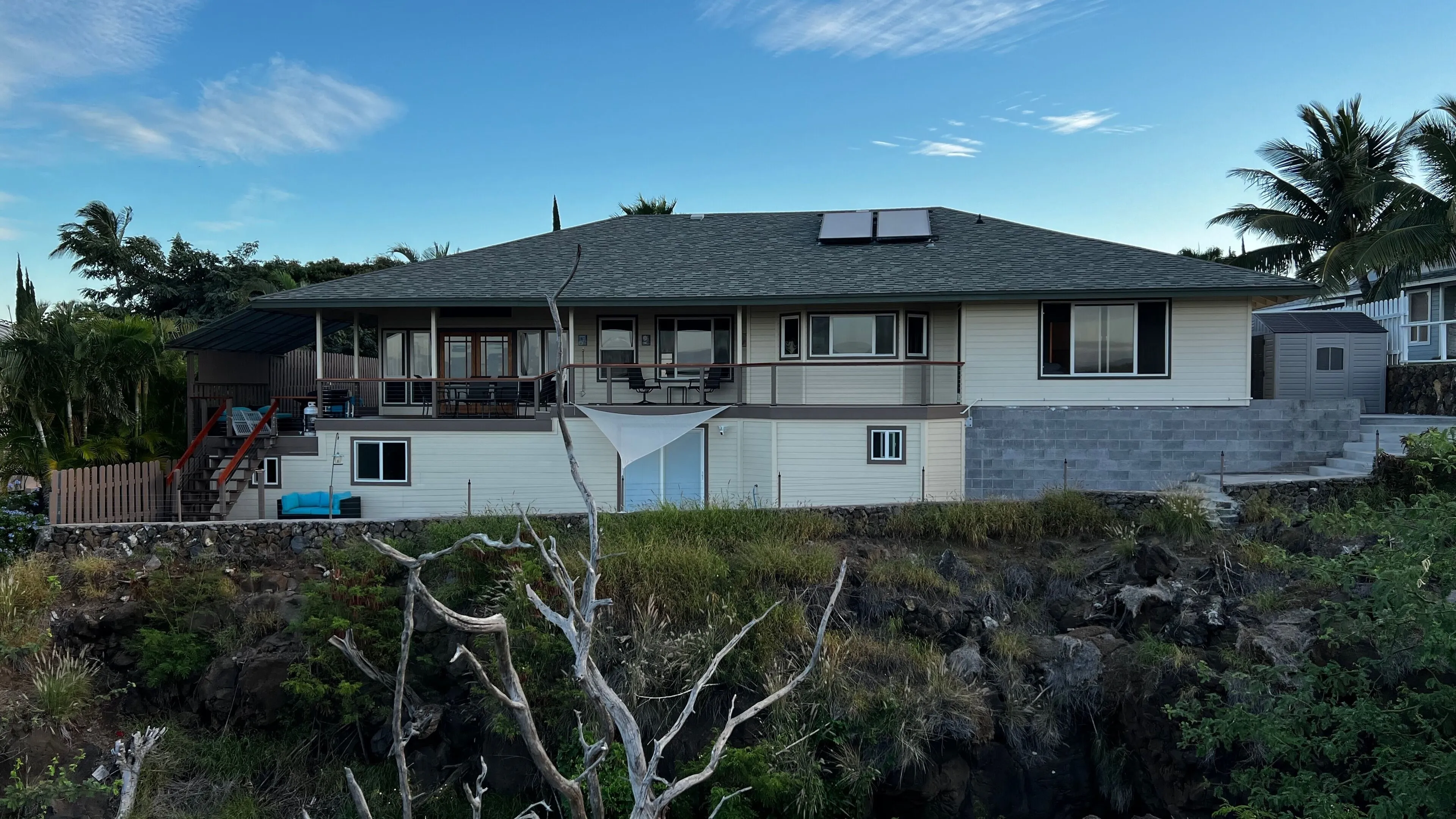 The home and lanai seen from the hillside below
