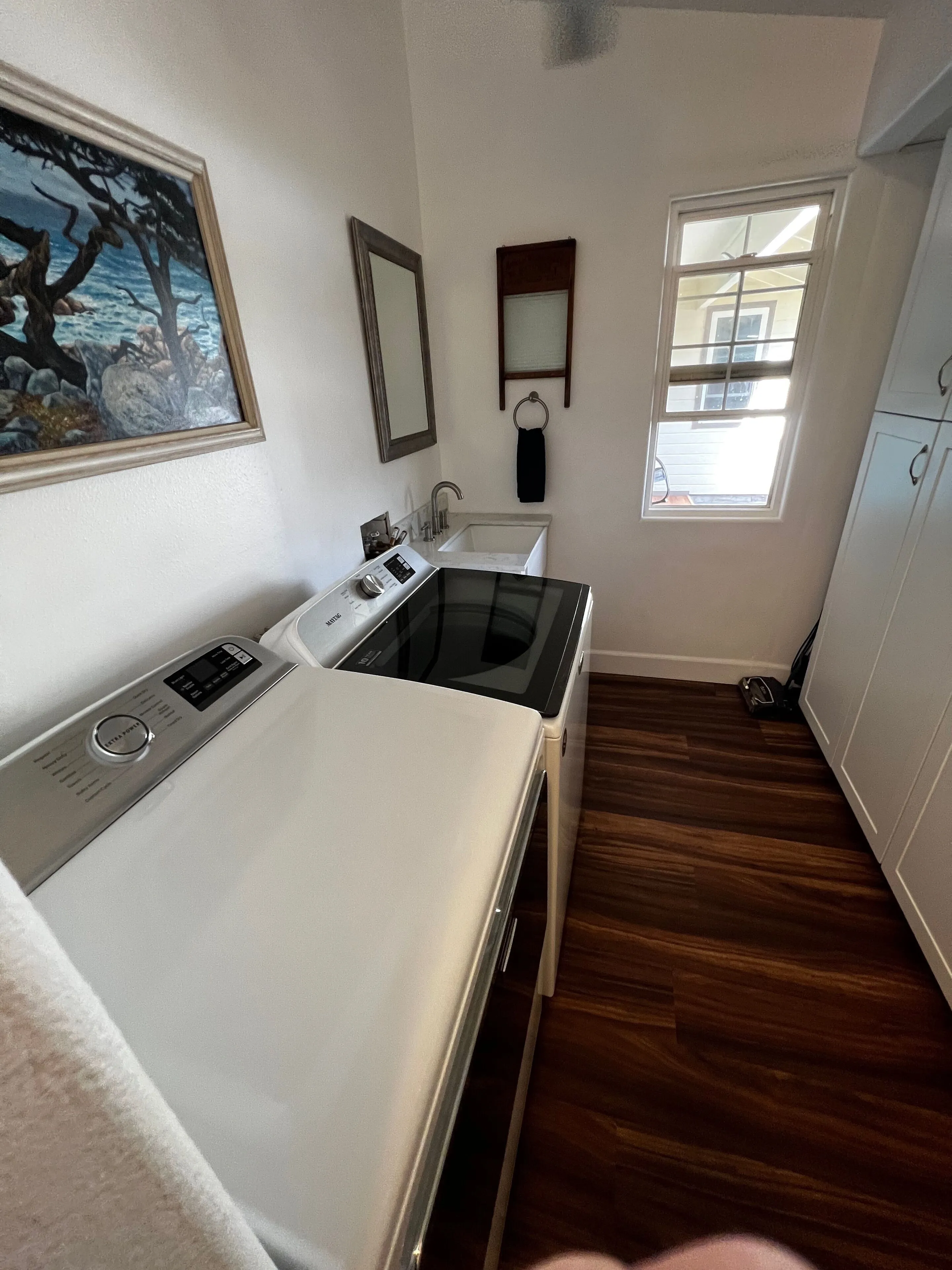 Laundry room with washer and utility sink