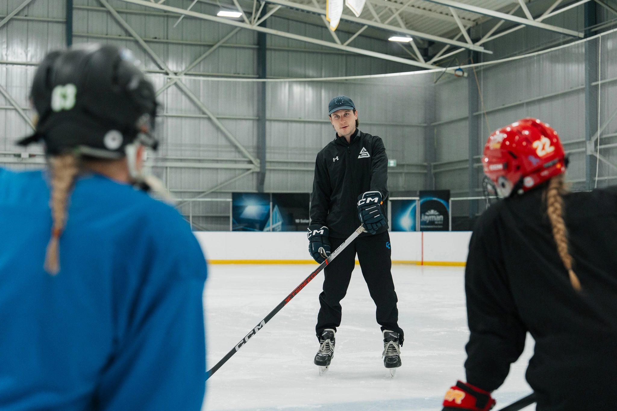 Image of Cole McBride coaching an on-ice skating session