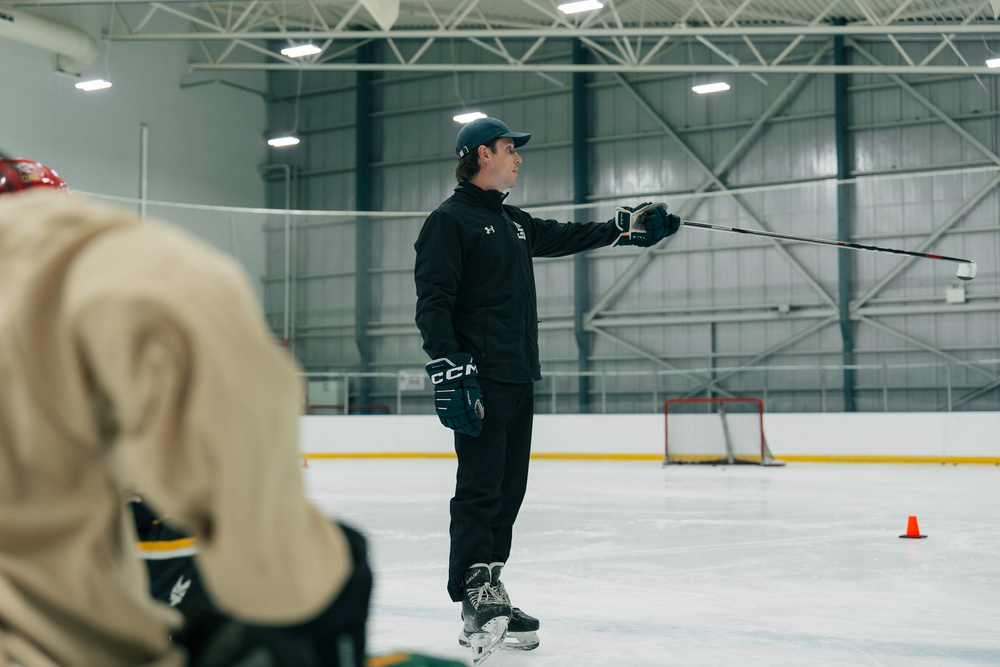 Image of Cole McBride coaching an on-ice skating session
