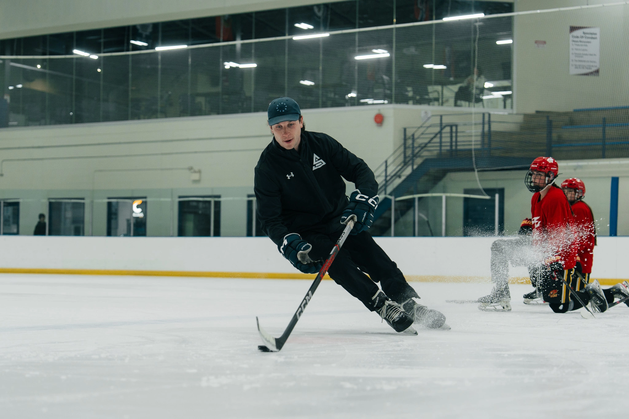 Image of Cole McBride coaching an on-ice skating session