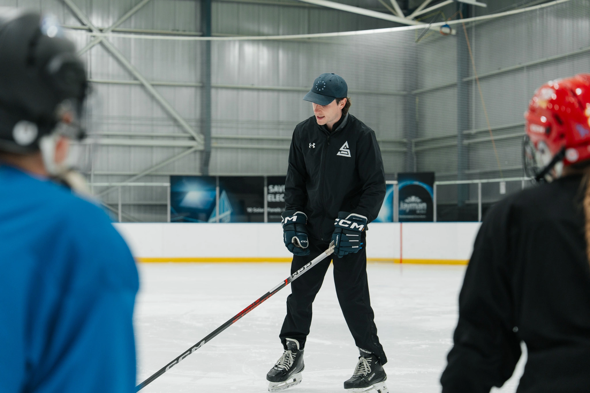 Image of Cole McBride coaching an on-ice skating session