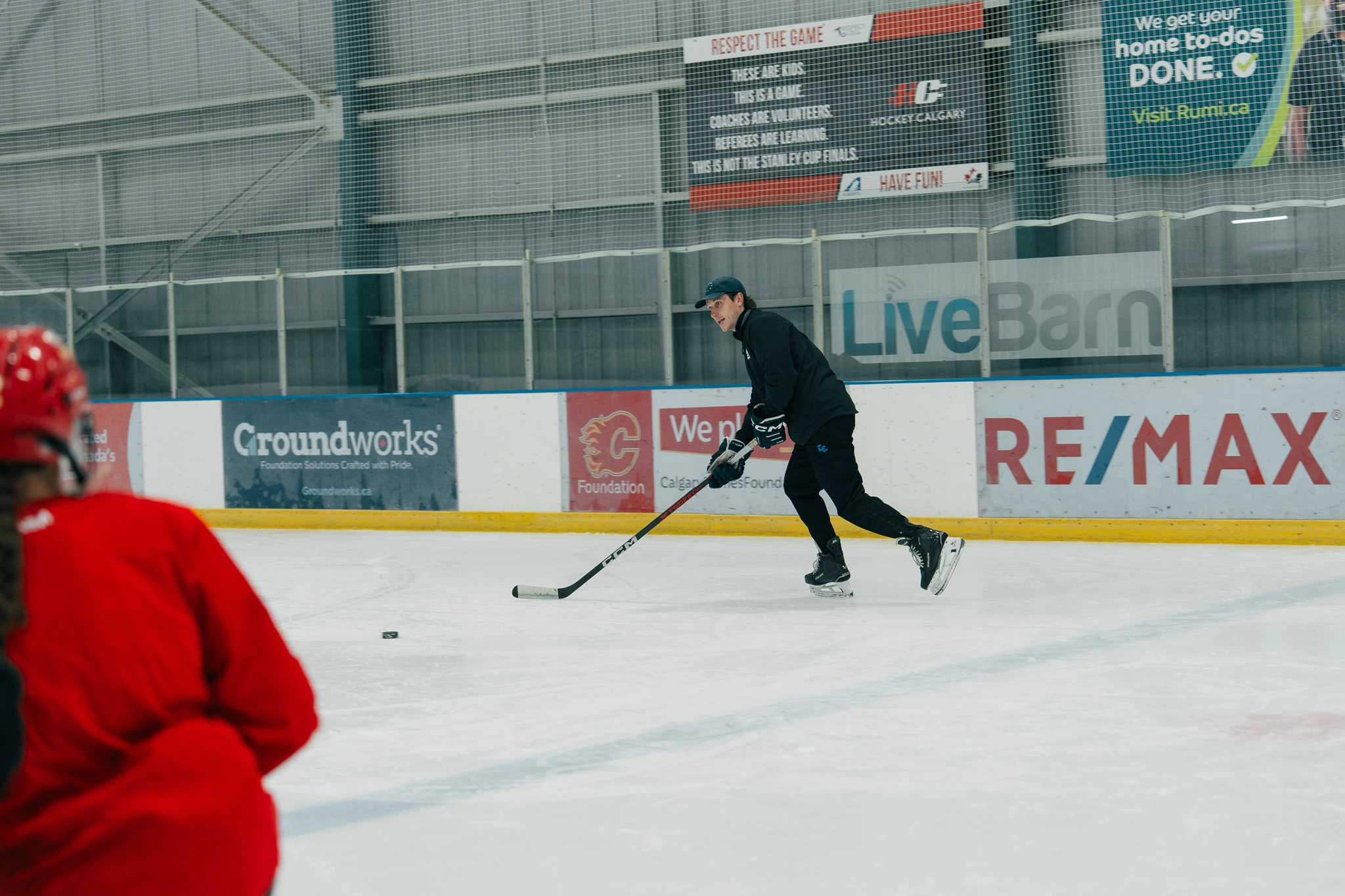 Image of Cole McBride coaching an on-ice skating session