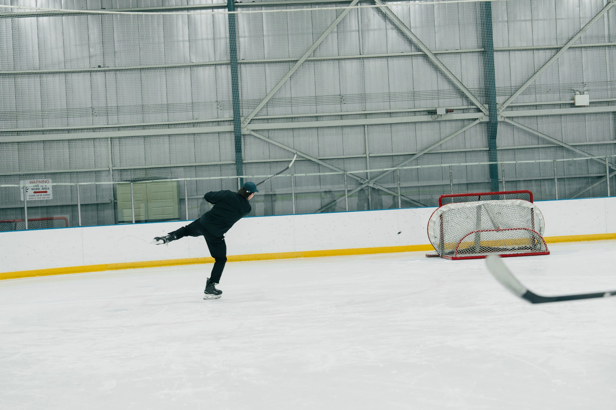 Image of Cole McBride coaching an on-ice skating session
