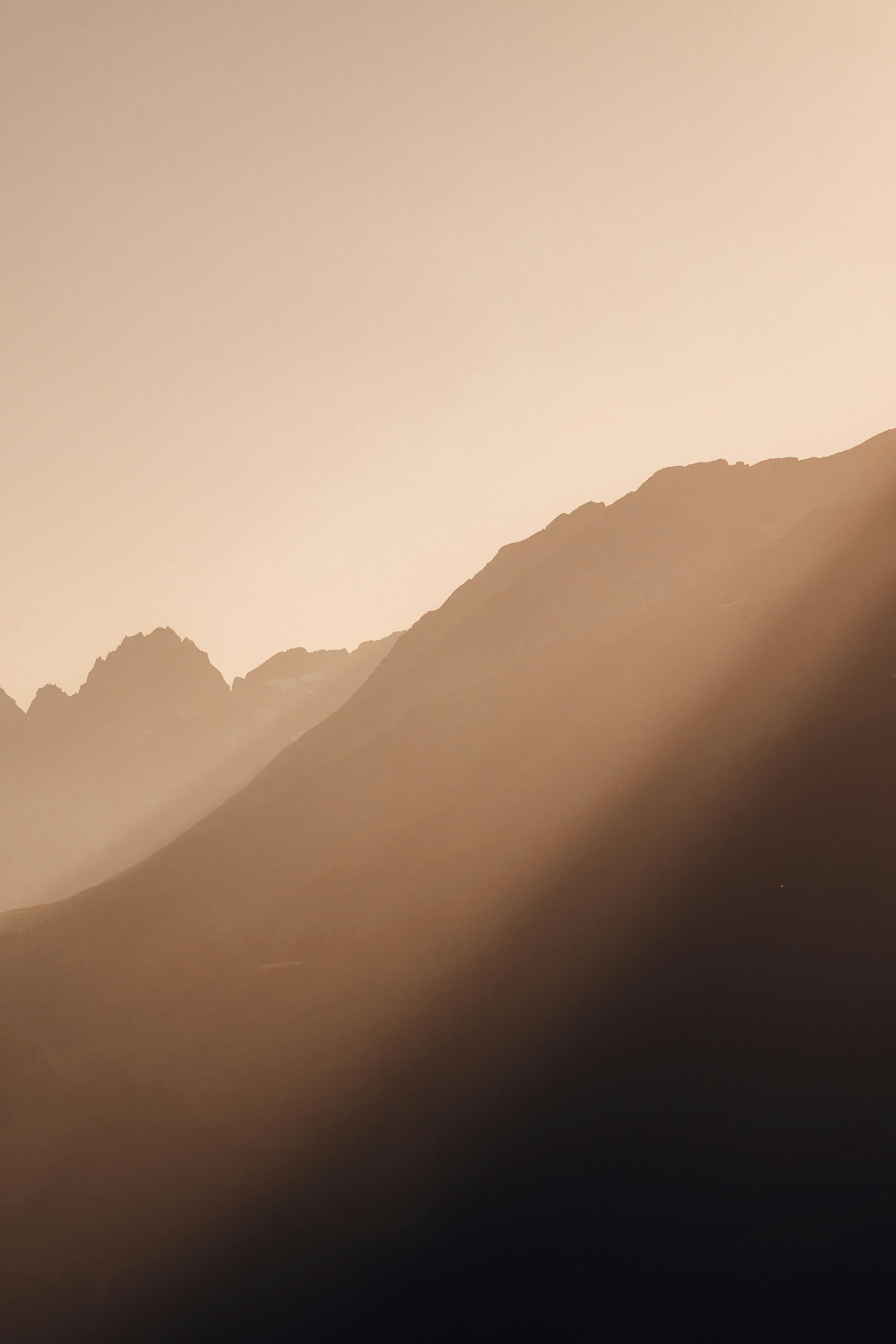 A woman holding her hands as a heart while sitting in an infinity pool.
