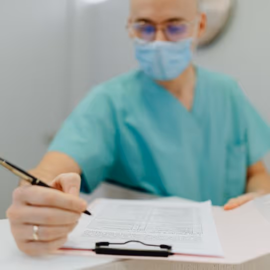 Surgeon writing on a notepad