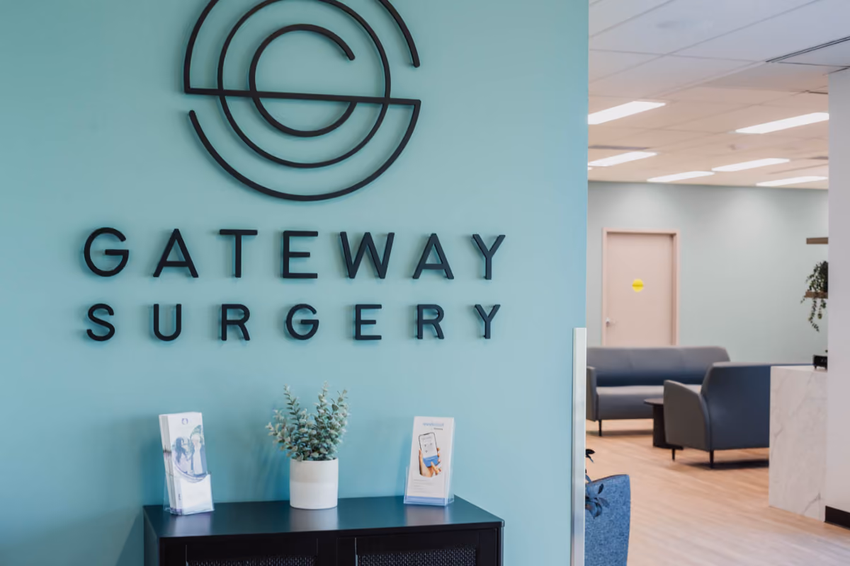 Gateway Surgery clinic front desk featuring logo, pamphlets, welcome area.