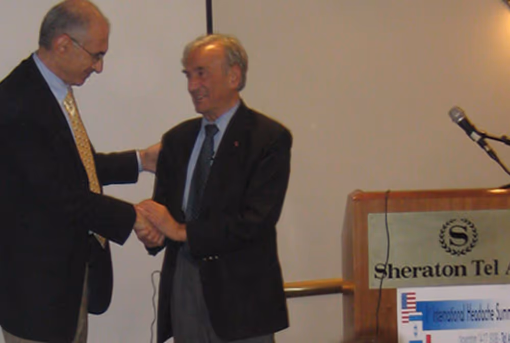 Handshake at the International Headache Summit in Tel Aviv with Nobel Laureate Elie Wiesel.