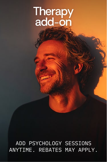 Smiling man with curly hair lit by warm orange light, text reads 'Therapy add-on' and 'Add psychology sessions anytime. Rebates may apply.'