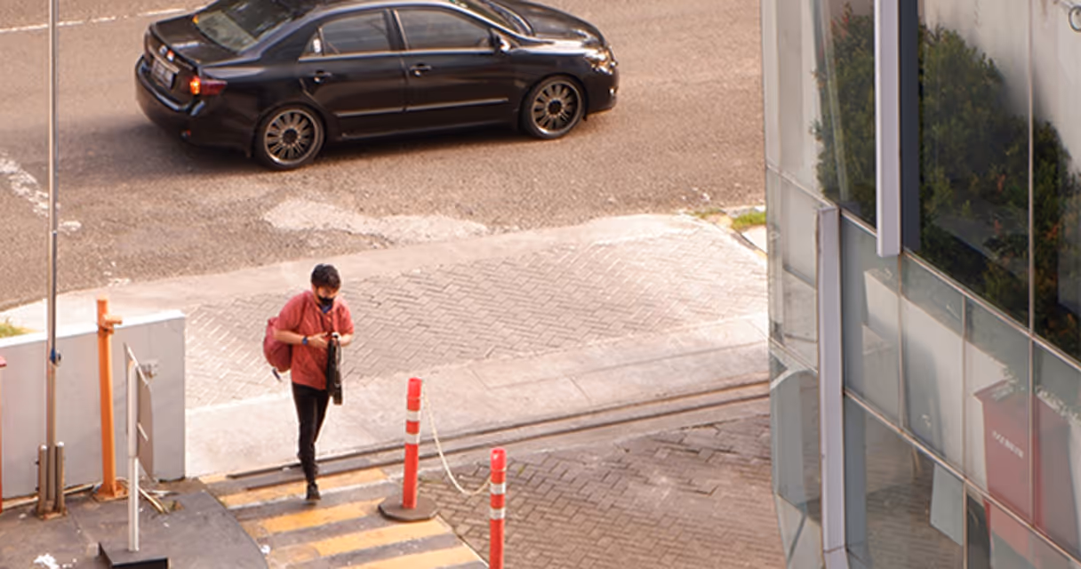 Man exiting vehicle in front of building