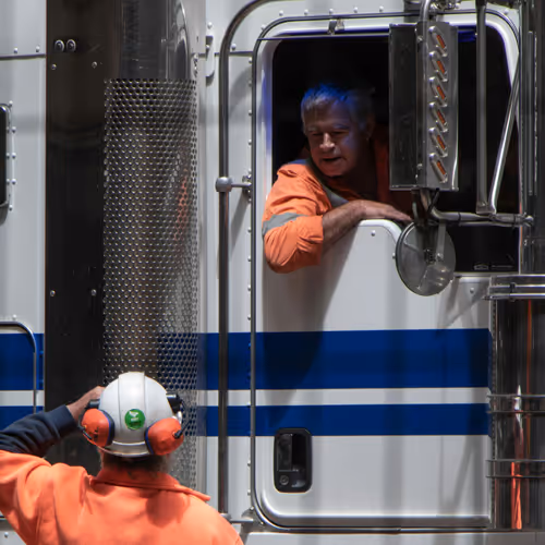 Worker talking with truck driver