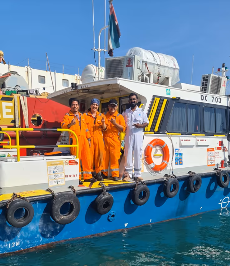 A group of men standing on a boat.