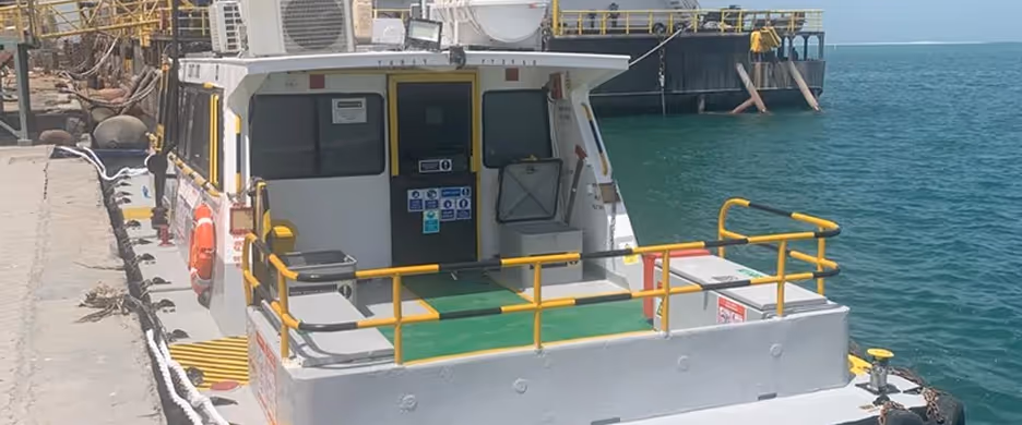 A boat with a yellow and black striped walkway.