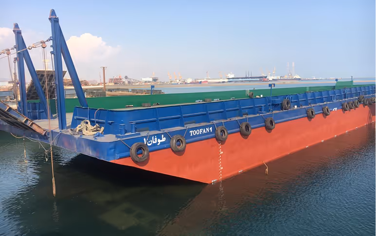 A large blue and red boat with the word toofan on it.